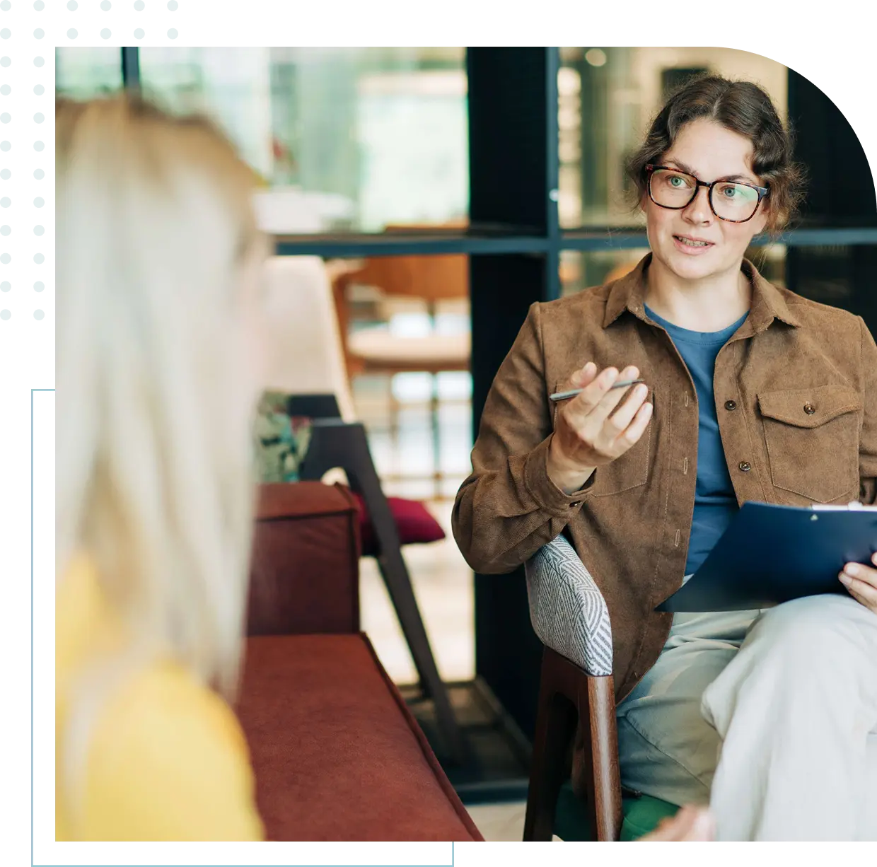 Two women having a discussion in office.