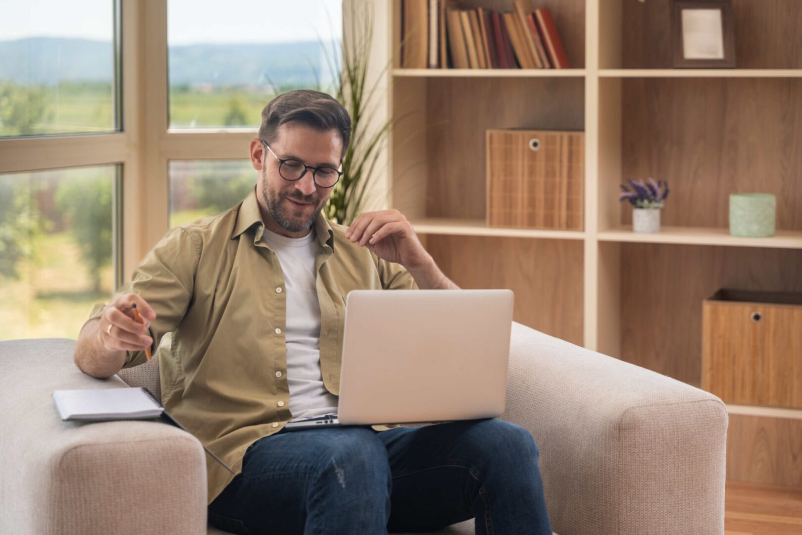 Man working on laptop at home.