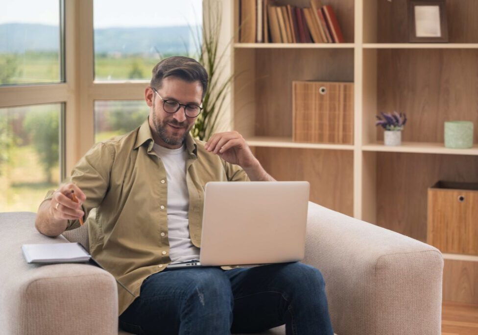 Man working on laptop at home.